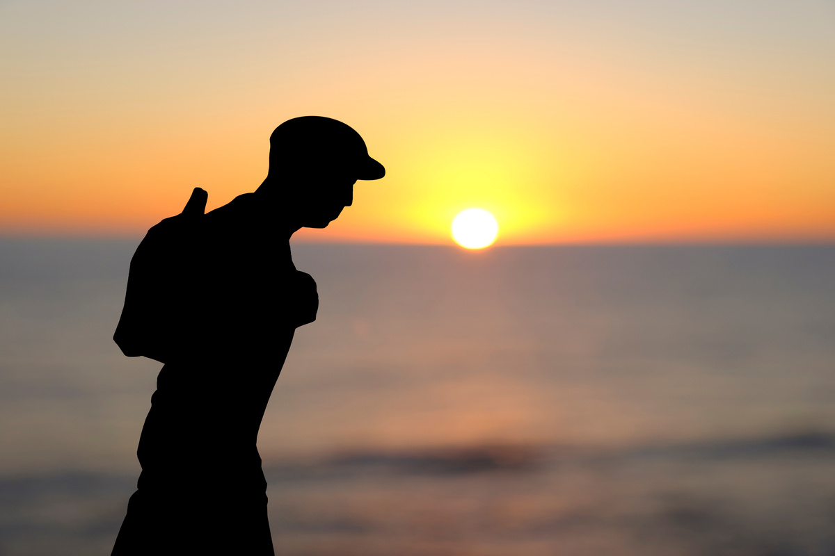 Silhouette of a Backpacker Man at Sunset